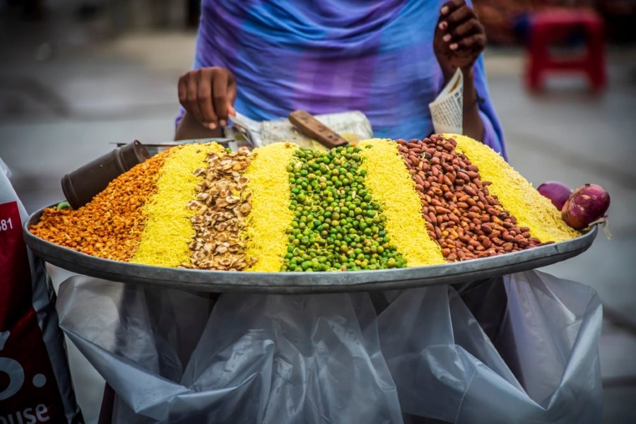Assorted Indian savoury snack mixes on a vendor tray