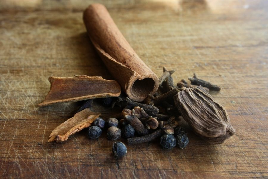 Whole Indian spices including cinnamon, cardamom and cloves
